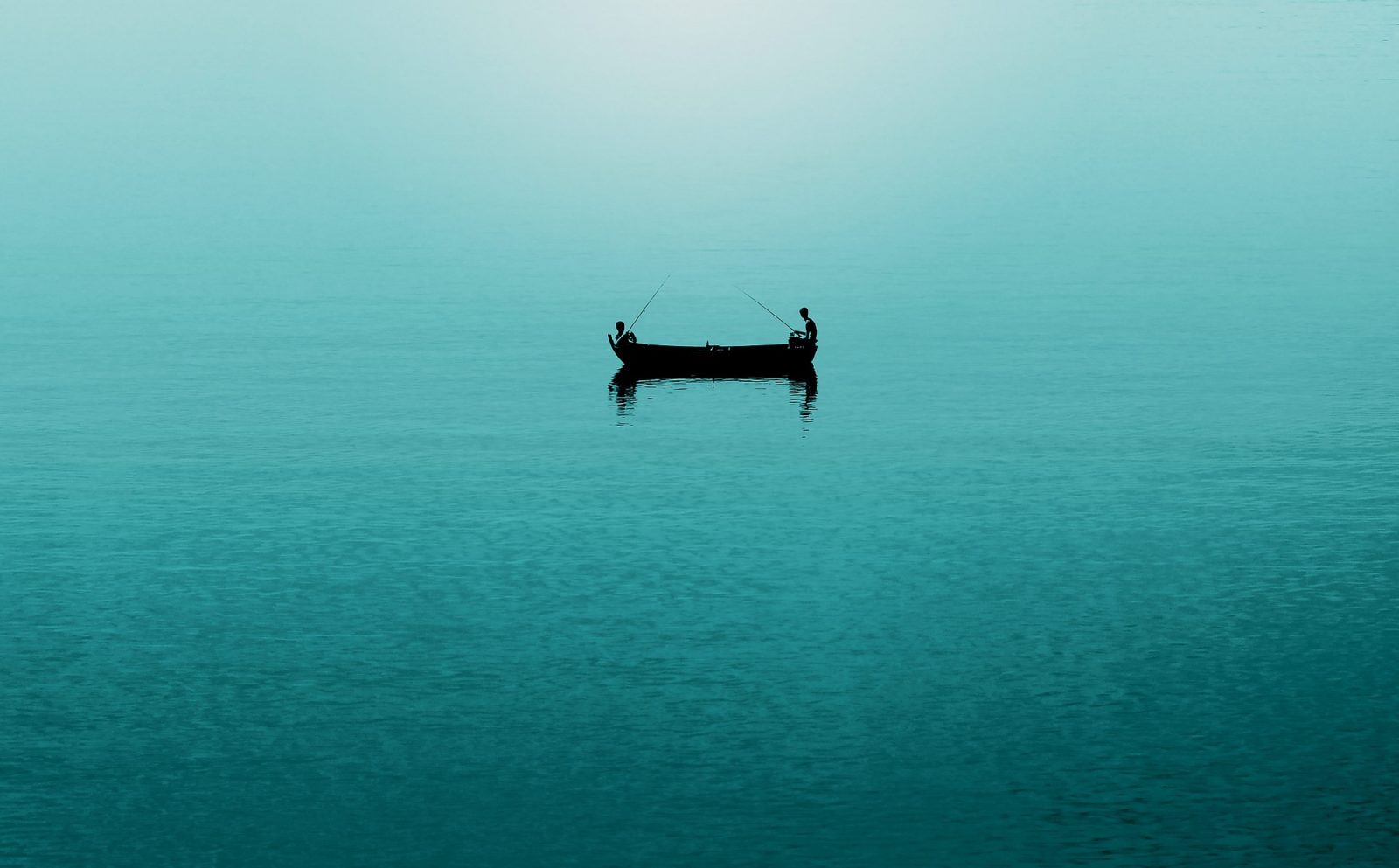 Two anglers fishing from a boat on open water